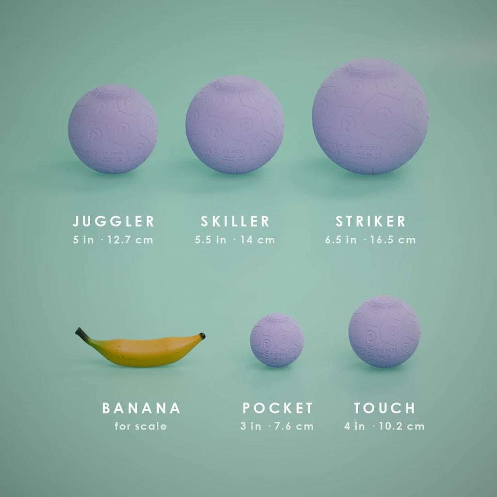 All five Nil Ball sizes in Lilac at true scale, with a banana for scale