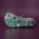 Nine metal blade studs on a Prevolve Green pitcher build, sole view, plum studio backdrop